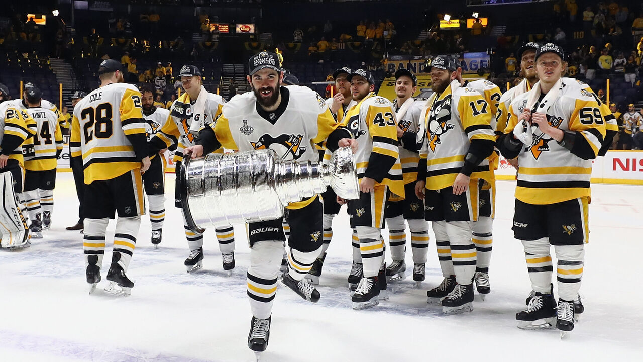 NASHVILLE, TN - JUNE 11: Justin Schultz #4 of the Pittsburgh Penguins celebrates with the Stanley Cup following a victory over the Nashville Predators in Game Six of the 2017 NHL Stanley Cup Final at the Bridgestone Arena on June 11, 2017 in Nashville, Tennessee.