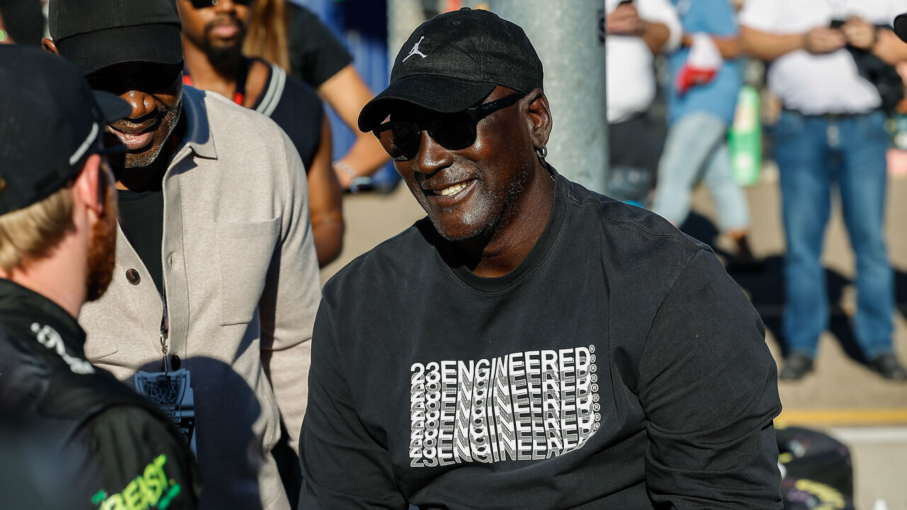 AVONDALE, AZ - NOVEMBER 09: Michael Jordan smiles while talking to Tyler Reddick (#45 23XI Racing The Beast Unleashed Toyota) before qualifying for the NASCAR Cup Series Championship Race on November 9, 2024 at Phoenix Raceway in Avondale, Arizona.