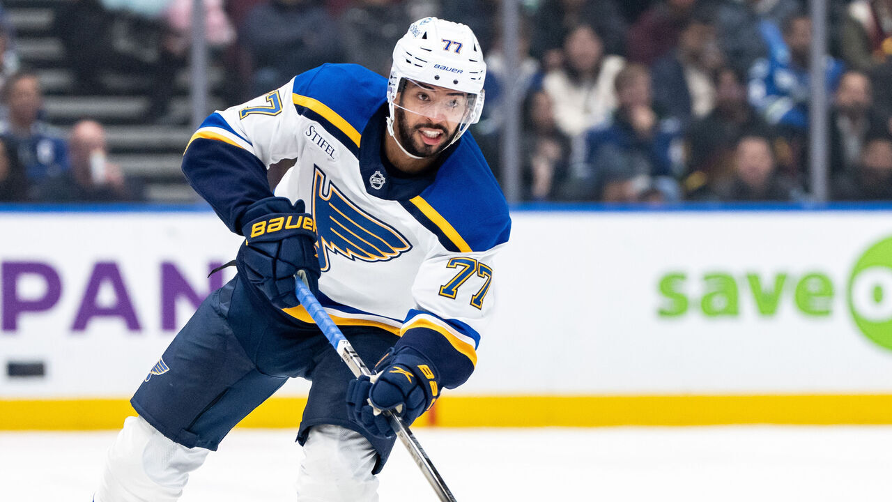 VANCOUVER, CANADA - DECEMBER 10: Pierre-Olivier Joseph #77 of the St. Louis Blues passes the puck during the third period of their NHL game against the Vancouver Canucks at Rogers Arena on December 10, 2024 in Vancouver, Canada.