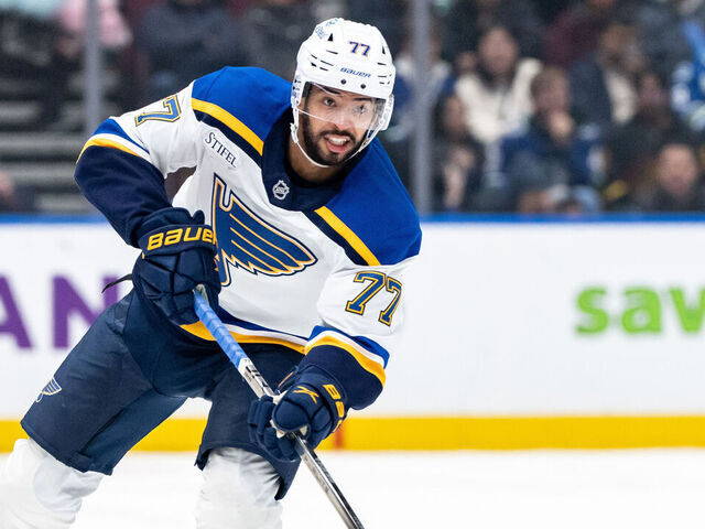 VANCOUVER, CANADA - DECEMBER 10: Pierre-Olivier Joseph #77 of the St. Louis Blues passes the puck during the third period of their NHL game against the Vancouver Canucks at Rogers Arena on December 10, 2024 in Vancouver, Canada.