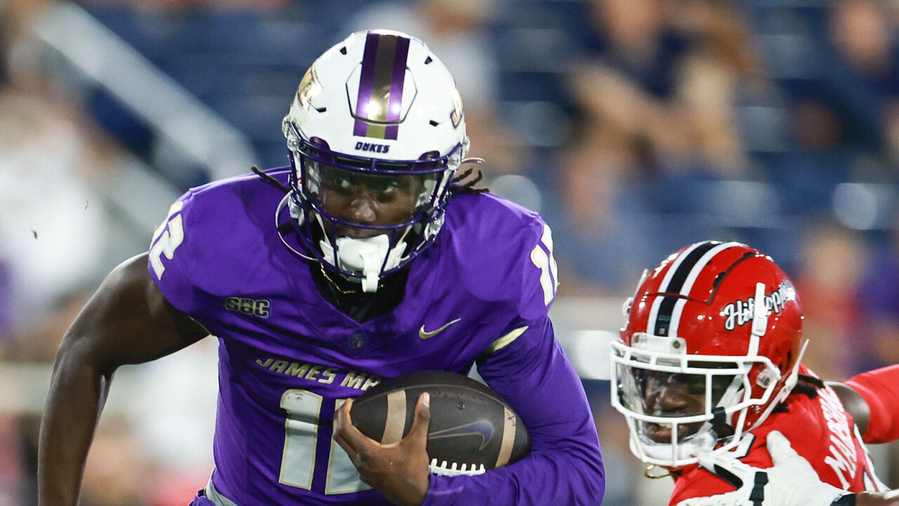 BOCA RATON, FLORIDA - DECEMBER 18: JC Evans #12 of the James Madison Dukes rushes against the Western Kentucky Hilltoppers during the first half at FAU Stadium on December 18, 2024 in Boca Raton, Florida.