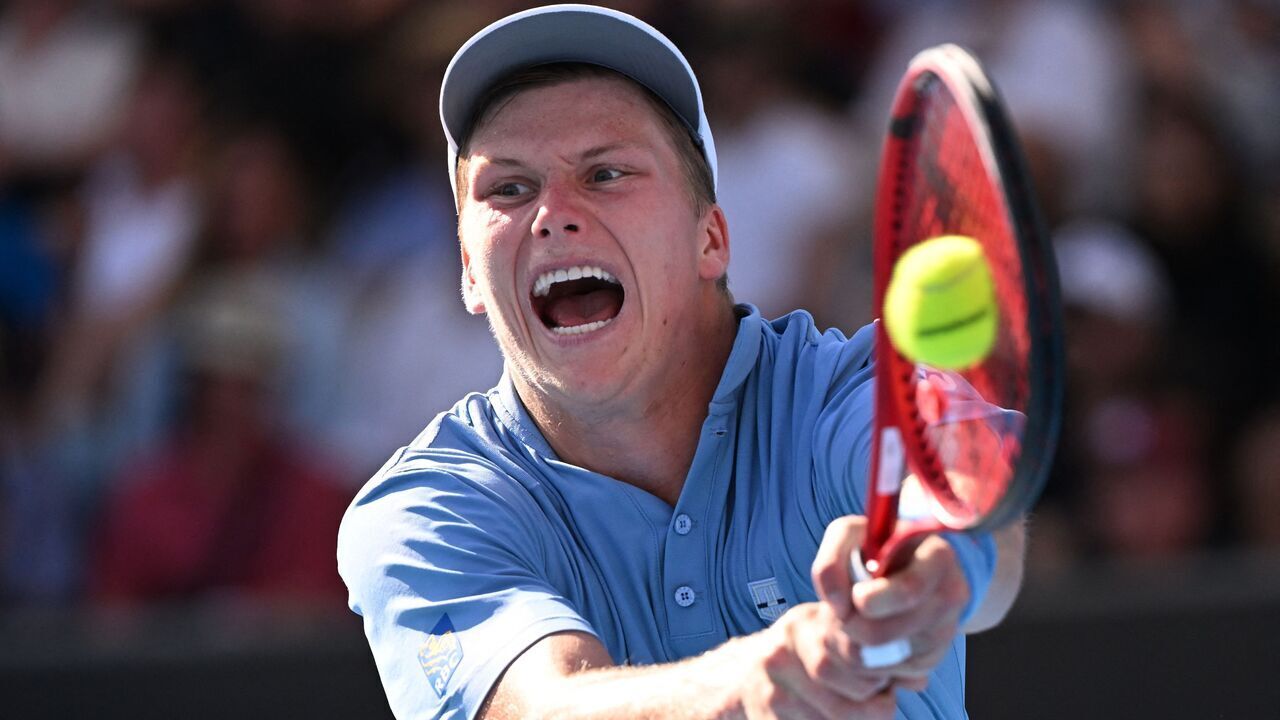TOPSHOT - USA's Jenson Brooksby hits a return against USA's Tommy Paul during their men's singles match on day six of the Australian Open tennis tournament in Melbourne on January 21, 2023. - -- IMAGE RESTRICTED TO EDITORIAL USE - STRICTLY NO COMMERCIAL USE --