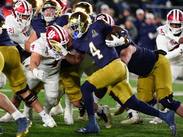 SOUTH BEND, IN - DECEMBER 20: Notre Dame Fighting Irish running back Jeremiyah Love (4) breaks a 98 yard run for a touchdown against the Indiana Hoosiers on December 20, 2024, during the CFP First Round playoff game at Notre Dame Stadium in South Bend, Indiana.