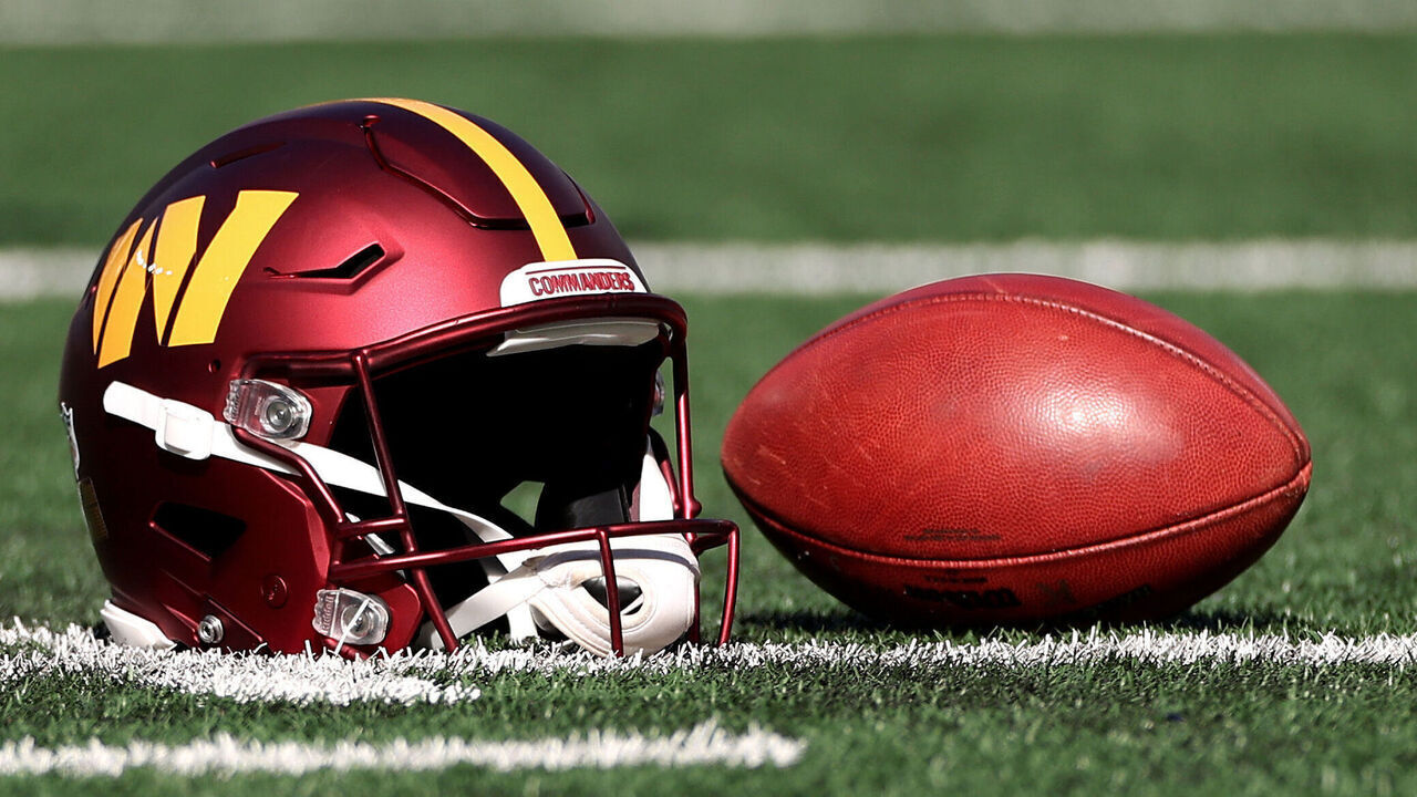 EAST RUTHERFORD, NEW JERSEY - NOVEMBER 03: A detailed view of a Washington Commanders helmet and football before the game against the New York Giants at MetLife Stadium on November 03, 2024 in East Rutherford, New Jersey.