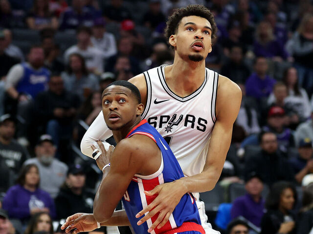 SACRAMENTO, CALIFORNIA - DECEMBER 01: Victor Wembanyama #1 of the San Antonio Spurs and De'Aaron Fox #5 of the Sacramento Kings go for a rebound in the first half at Golden 1 Center on December 01, 2024 in Sacramento, California. NOTE TO USER: User expressly acknowledges and agrees that, by downloading and/or using this photograph, user is consenting to the terms and conditions of the Getty Images License Agreement.