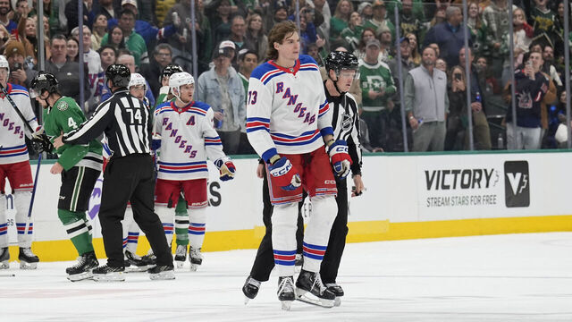 DALLAS, TX - DECEMBER 20: Matt Rempe #73 of the New York Rangers escorted off the ice against the Dallas Stars at the American Airlines Center on December 20, 2024 in Dallas, Texas.