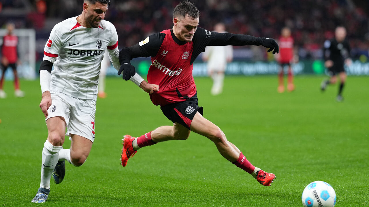 Freiburg's Italian midfielder #32 Vincenzo Grifo and Bayer Leverkusen's German midfielder #10 Florian Wirtz (R) vie for the ball during the German first division Bundesliga football match between Bayer Leverkusen and SC Freiburg in Leverkusen on December 21, 2024.