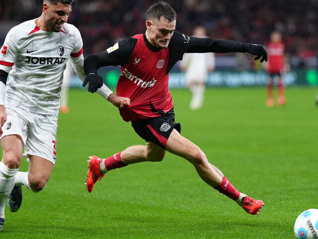 Freiburg's Italian midfielder #32 Vincenzo Grifo and Bayer Leverkusen's German midfielder #10 Florian Wirtz (R) vie for the ball during the German first division Bundesliga football match between Bayer Leverkusen and SC Freiburg in Leverkusen on December 21, 2024.