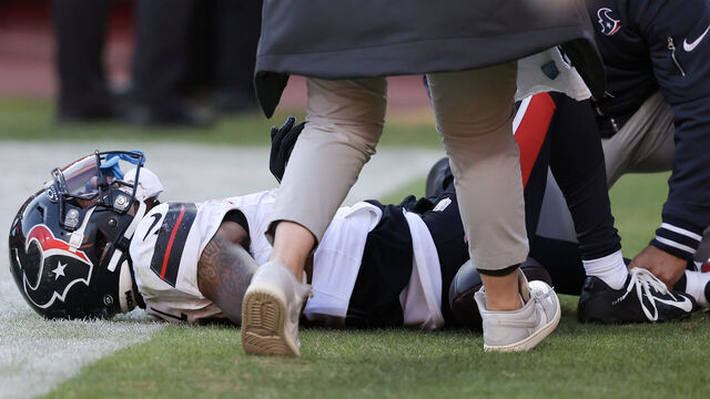 KANSAS CITY, MISSOURI - DECEMBER 21: Medical staff look at Tank Dell #3 of the Houston Texans after Dell sustained an injury while catching a touchdown in the third quarter of a game against the Kansas City Chiefs at GEHA Field at Arrowhead Stadium on December 21, 2024 in Kansas City, Missouri.