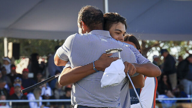 ORLANDO, FLORIDA - DECEMBER 21: Charlie Woods hugs his father Tiger Woods on the 18th hole green after their first round of the PNC Championship at Ritz-Carlton Golf Club on December 21, 2024 in Orlando, Florida.