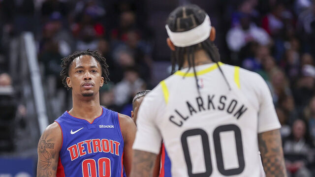 DETROIT, MICHIGAN - DECEMBER 19: Ron Holland II #00 of the Detroit Pistons looks at Jordan Clarkson #00 of the Utah Jazz after an altercation between the two during the third quarter of a game at Little Caesars Arena on December 19, 2024 in Detroit, Michigan.