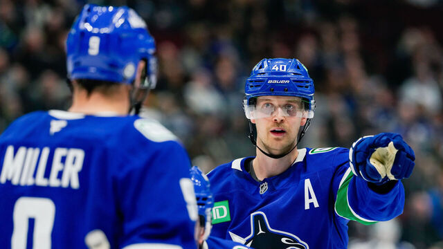 VANCOUVER, CANADA - NOVEMBER 14: Elias Pettersson #40 of the Vancouver Canucks signals to J.T. Miller #9 during the third period of their NHL game against the New York Islanders at Rogers Arena on November 14, 2024 in Vancouver, British Columbia, Canada.