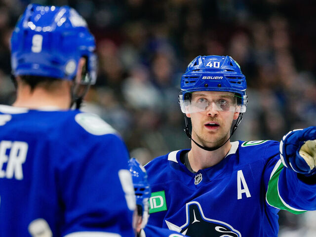 VANCOUVER, CANADA - NOVEMBER 14: Elias Pettersson #40 of the Vancouver Canucks signals to J.T. Miller #9 during the third period of their NHL game against the New York Islanders at Rogers Arena on November 14, 2024 in Vancouver, British Columbia, Canada.