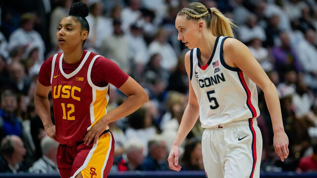 HARTFORD, CONNECTICUT - DECEMBER 21: JuJu Watkins #12 of the USC Trojans and Paige Bueckers #5 of the Connecticut Huskies play against each other during the first half of an NCAA women's basketball game at the XL Center on December 21, 2024 in Hartford, Connecticut.