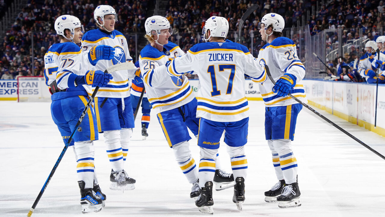 ELMONT, NEW YORK - DECEMBER 23: Jason Zucker #17 of the Buffalo Sabres is congratulated by his teammates after scoring a goal against the New York Islanders during the second period at UBS Arena on December 23, 2024 in Elmont, New York.