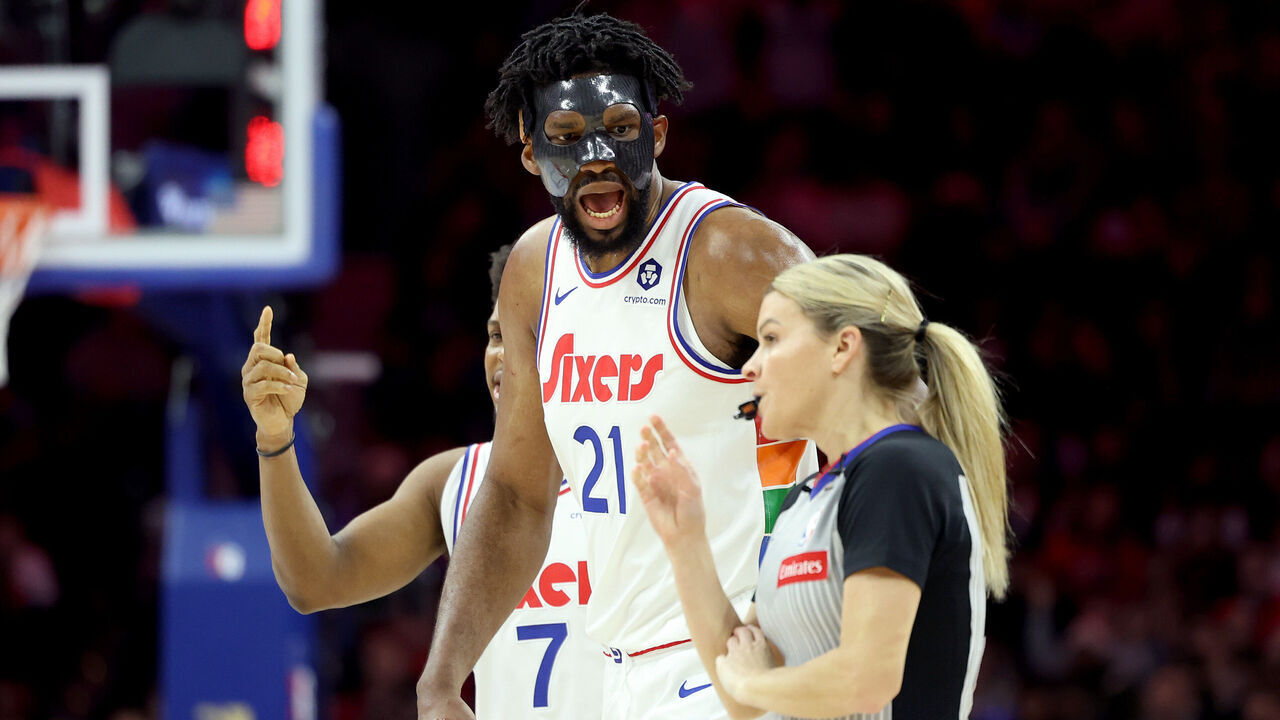 PHILADELPHIA, PENNSYLVANIA - DECEMBER 23: Joel Embiid #21 of the Philadelphia 76ers argues a call with referee Jenna Schroeder #20 during the first half against the San Antonio Spurs at the Wells Fargo Center on December 23, 2024 in Philadelphia, Pennsylvania. Embiid was ejected from the game with two technical fouls.