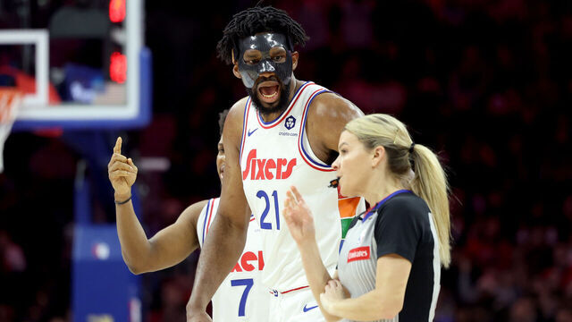 PHILADELPHIA, PENNSYLVANIA - DECEMBER 23: Joel Embiid #21 of the Philadelphia 76ers argues a call with referee Jenna Schroeder #20 during the first half against the San Antonio Spurs at the Wells Fargo Center on December 23, 2024 in Philadelphia, Pennsylvania. Embiid was ejected from the game with two technical fouls.