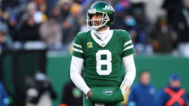 EAST RUTHERFORD, NEW JERSEY - DECEMBER 22: Aaron Rodgers #8 of the New York Jets looks on during the first half against the Los Angeles Rams at MetLife Stadium on December 22, 2024 in East Rutherford, New Jersey.