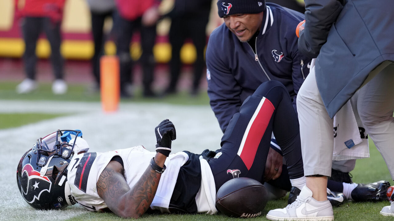 KANSAS CITY, MISSOURI - DECEMBER 21: Medical staff look at Tank Dell #3 of the Houston Texans after Dell sustained an injury while catching a touchdown in the third quarter of a game against the Kansas City Chiefs at GEHA Field at Arrowhead Stadium on December 21, 2024 in Kansas City, Missouri.