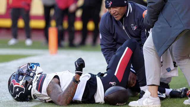 KANSAS CITY, MISSOURI - DECEMBER 21: Medical staff look at Tank Dell #3 of the Houston Texans after Dell sustained an injury while catching a touchdown in the third quarter of a game against the Kansas City Chiefs at GEHA Field at Arrowhead Stadium on December 21, 2024 in Kansas City, Missouri.