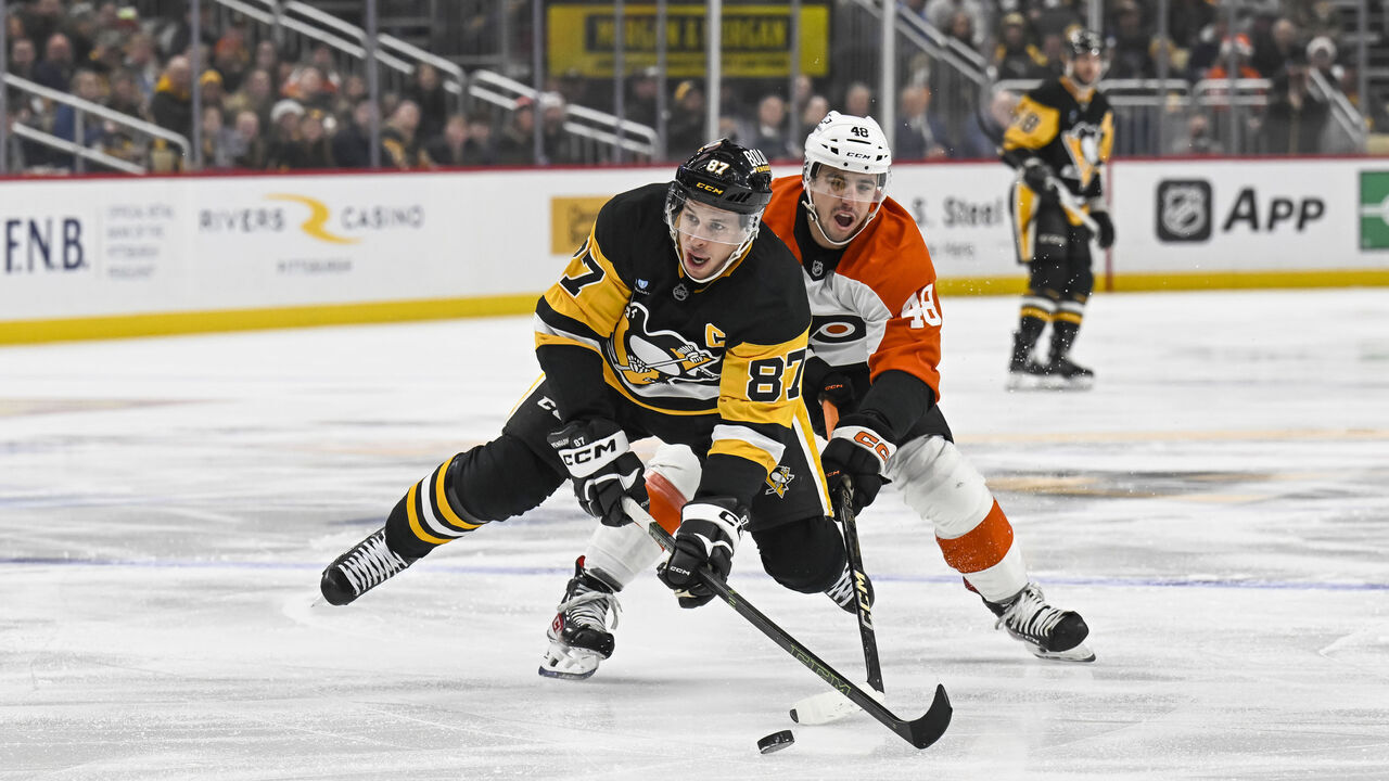 PITTSBURGH, PA - DECEMBER 23: Pittsburgh Penguins center Sidney Crosby (87) skates with the puck against Philadelphia Flyers center Morgan Frost (48) during the first period in the NHL game between the Pittsburgh Penguins and the Philadelphia Flyers on December 23, 2024, at PPG Paints Arena in Pittsburgh, PA.