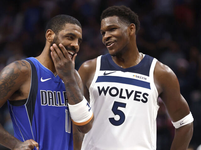 DALLAS, TX -DECEMBER 25 : Kyrie Irving #11 of the Dallas Mavericks and Anthony Edwards #5 of the Minnesota Timberwolves talk late in the second half at American Airlines Center on December 25, 2024 in Dallas, Texas.