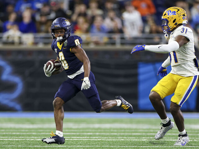 DETROIT, MICHIGAN - DECEMBER 26: Jacquez Stuart #0 of the Toledo Rockets runs the ball up the field against Rasheem Biles #31 of the Pittsburgh Panthers in the first quarter of the GameAbove Sports Bowl game at Ford Field on December 26, 2024 in Detroit, Michigan.