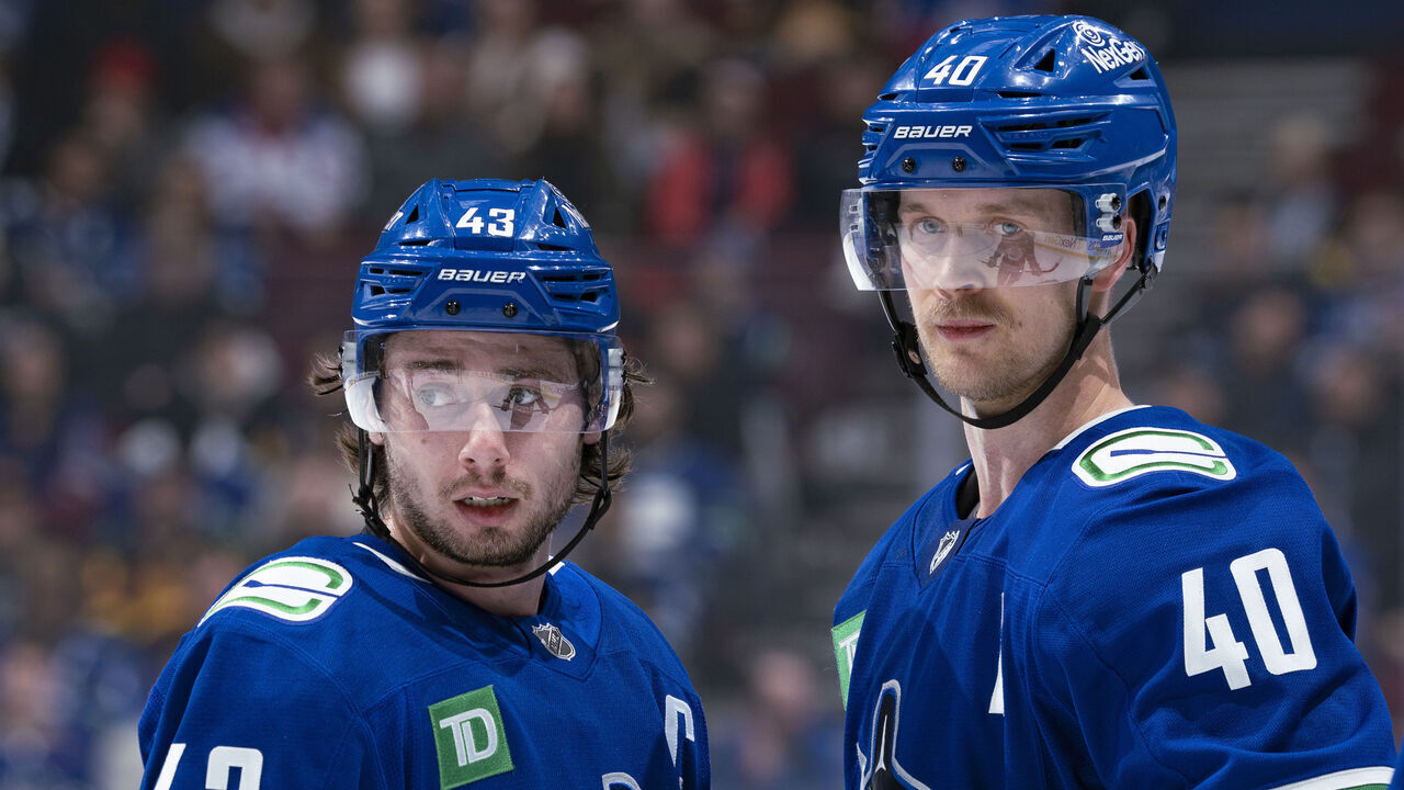 VANCOUVER, CANADA - NOVEMBER 19: Elias Pettersson #40 and Quinn Hughes #43 of the Vancouver Canucks talk during their NHL game against the New York Rangers at Rogers Arena on November 19, 2024 in Vancouver, British Columbia, Canada.