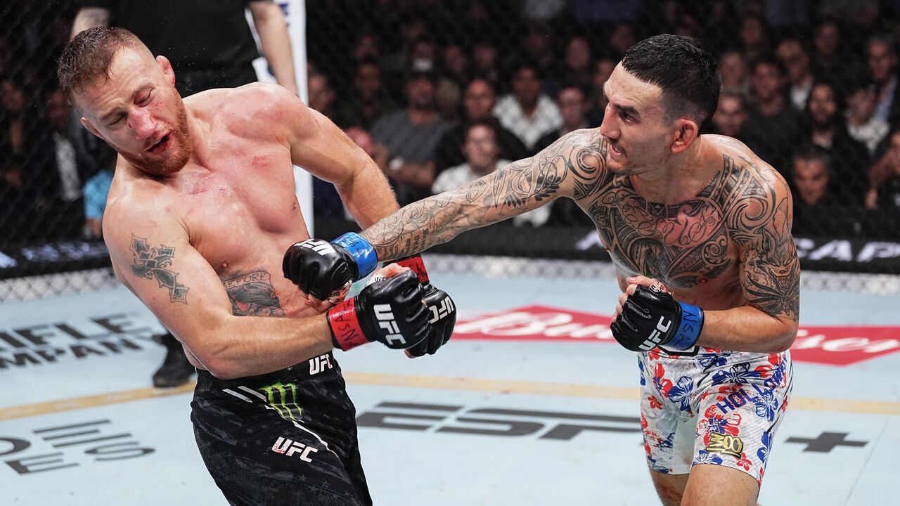 LAS VEGAS, NEVADA - APRIL 13: (R-L) Max Holloway punches Justin Gaethje in the BMF championship fight during the UFC 300 event at T-Mobile Arena on April 13, 2024 in Las Vegas, Nevada.