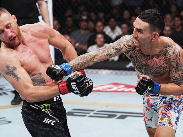 LAS VEGAS, NEVADA - APRIL 13: (R-L) Max Holloway punches Justin Gaethje in the BMF championship fight during the UFC 300 event at T-Mobile Arena on April 13, 2024 in Las Vegas, Nevada.