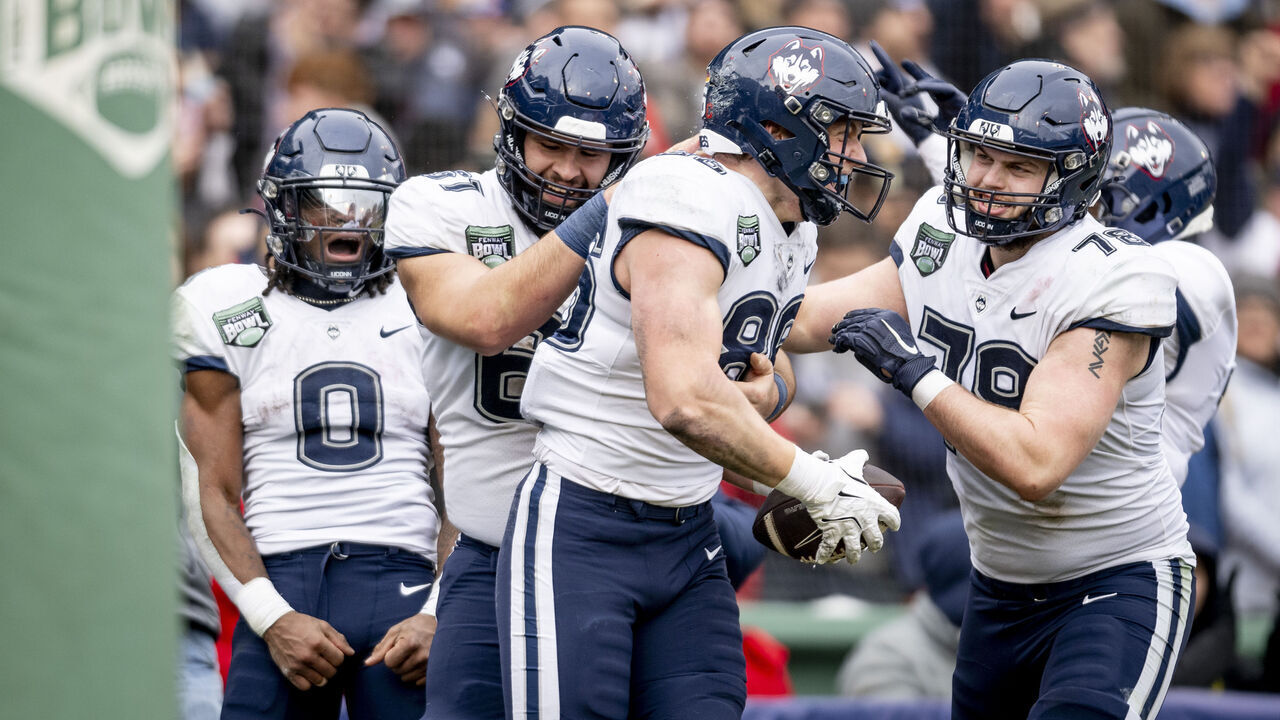 BOSTON, MASSACHUSETTS - DECEMBER 28: Alex Honig #86 of the Connecticut Huskies reacts after a touchdown during the first half of the 2024 Wasabi Fenway Bowl game against the North Carolina Tar Heels on December 28, 2024 at Fenway Park in Boston, Massachusetts.