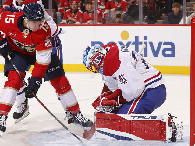 SUNRISE, FLORIDA - DECEMBER 28: Goaltender Jakub Dobes #75 of the Montreal Canadianscdefends the net against Anton Lundell #15 of the Florida Panthers at the Amerant Bank Arena on December 28, 2024 in Sunrise, Florida.