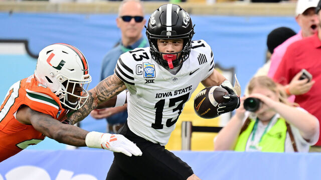 ORLANDO, FLORIDA - DECEMBER 28: Jaylin Noel #13 of the Iowa State Cyclones breaks a tackle from Zaquan Patterson #20 of the Miami Hurricanes after a 49-yard reception in the first quarter during the 2024 Pop-Tarts Bowl at Camping World Stadium on December 28, 2024 in Orlando, Florida.