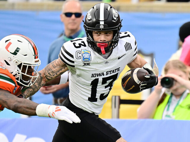 ORLANDO, FLORIDA - DECEMBER 28: Jaylin Noel #13 of the Iowa State Cyclones breaks a tackle from Zaquan Patterson #20 of the Miami Hurricanes after a 49-yard reception in the first quarter during the 2024 Pop-Tarts Bowl at Camping World Stadium on December 28, 2024 in Orlando, Florida.