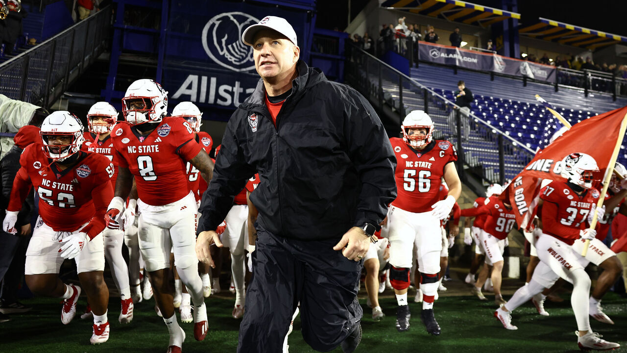 ANNAPOLIS, MARYLAND - DECEMBER 28: Head coach Dave Doeren of the North Carolina State Wolfpack (C) looks on during the Go Bowling Military Bowl at Navy-Marine Corps Memorial Stadium on December 28, 2024 in Annapolis, Maryland.