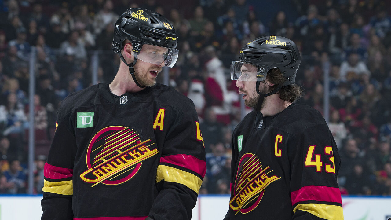 VANCOUVER, CANADA - DECEMBER 21: Elias Pettersson #40 of the Vancouver Canucks talks to Quinn Hughes #43 during their NHL game against the Ottawa Senators at Rogers Arena on December 21, 2024 in Vancouver, British Columbia, Canada.