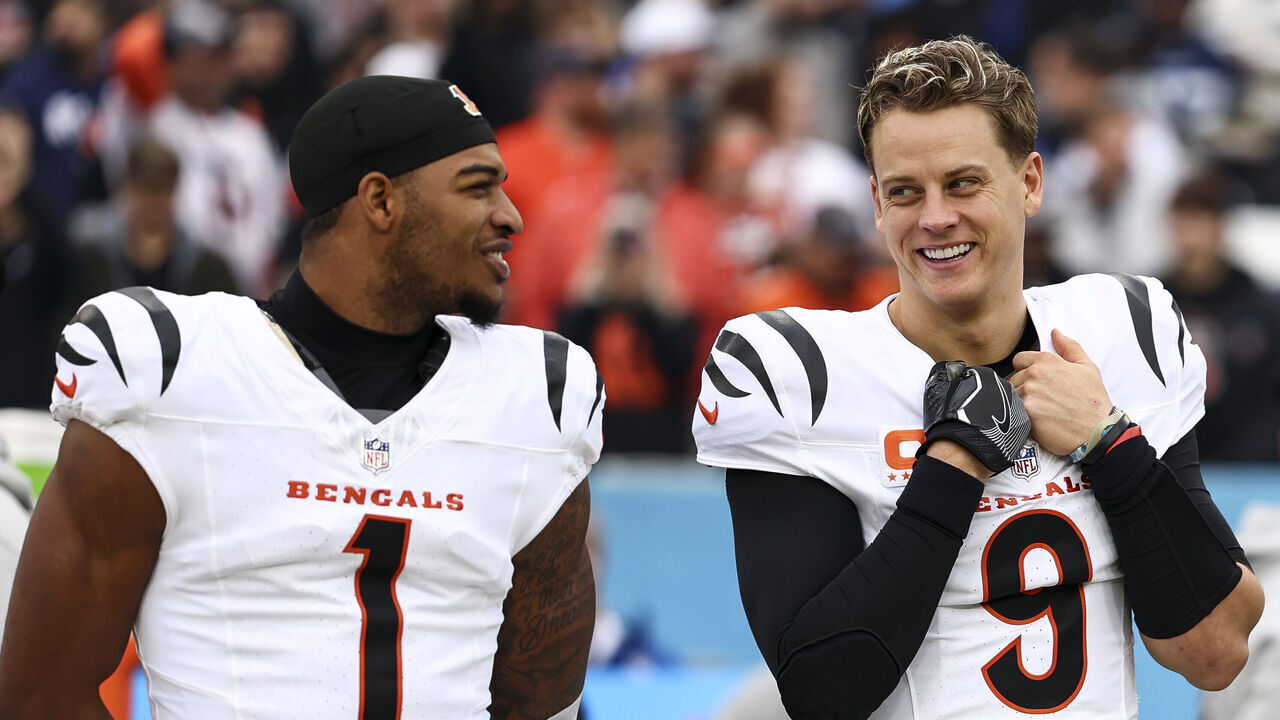 NASHVILLE, TENNESSEE - DECEMBER 15: Joe Burrow #9 of the Cincinnati Bengals smiles with Ja'Marr Chase #1 prior to an NFL football game against the Tennessee Titans at Nissan Stadium on December 15, 2024 in Nashville, Tennessee.