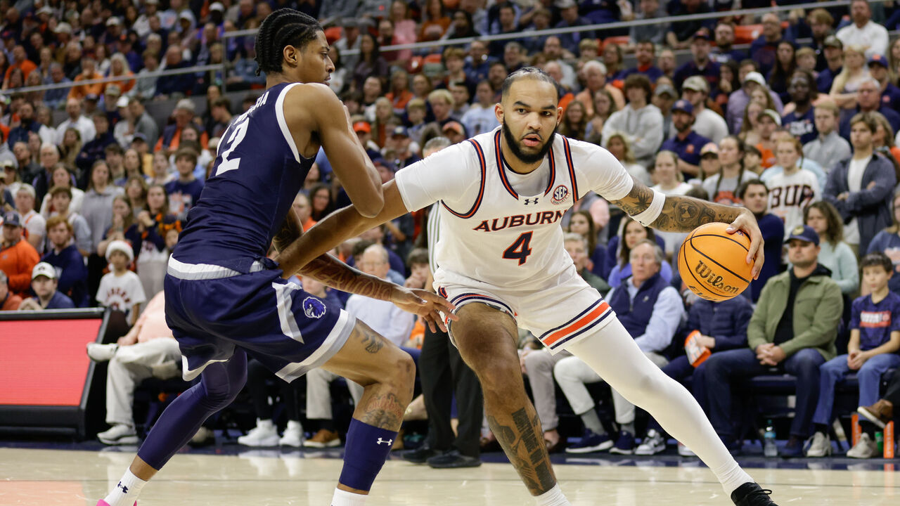 AUBURN, ALABAMA - DECEMBER 30: Johni Broome #4 of the Auburn Tigers dribbles the ball as Jaret Valencia #2 of the Monmouth Hawks defends during the first half at Neville Arena on December 30, 2024 in Auburn, Alabama.