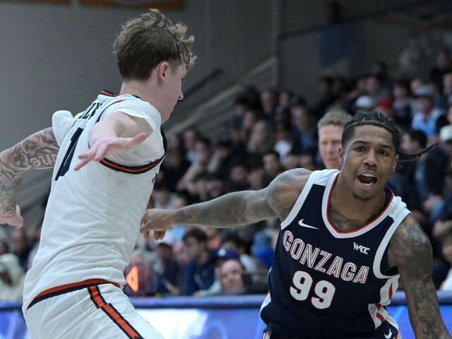 MALIBU, CALIFORNIA - DECEMBER 30: Khalif Battle #99 of the Gonzaga Bulldogs drives past Jaxon Olvera #10 of the Pepperdine Waves in the second half at Firestone Fieldhouse on December 30, 2024 in Malibu, California.