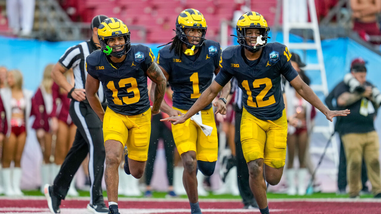 TAMPA, FL - DECEMBER 31: Michigan Wolverines defensive back Wesley Walker (13), Michigan Wolverines linebacker Jaishawn Barham (1), and Michigan Wolverines defensive back Aamir Hall (12) celebrate after a turnover during the ReliaQuest Bowl between the Alabama Crimson Tide and the Michigan Wolverines, December 31, 2024 at Raymond James Stadium in Tampa, Florida.