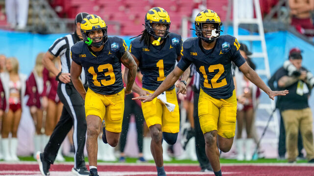 TAMPA, FL - DECEMBER 31: Michigan Wolverines defensive back Wesley Walker (13), Michigan Wolverines linebacker Jaishawn Barham (1), and Michigan Wolverines defensive back Aamir Hall (12) celebrate after a turnover during the ReliaQuest Bowl between the Alabama Crimson Tide and the Michigan Wolverines, December 31, 2024 at Raymond James Stadium in Tampa, Florida.