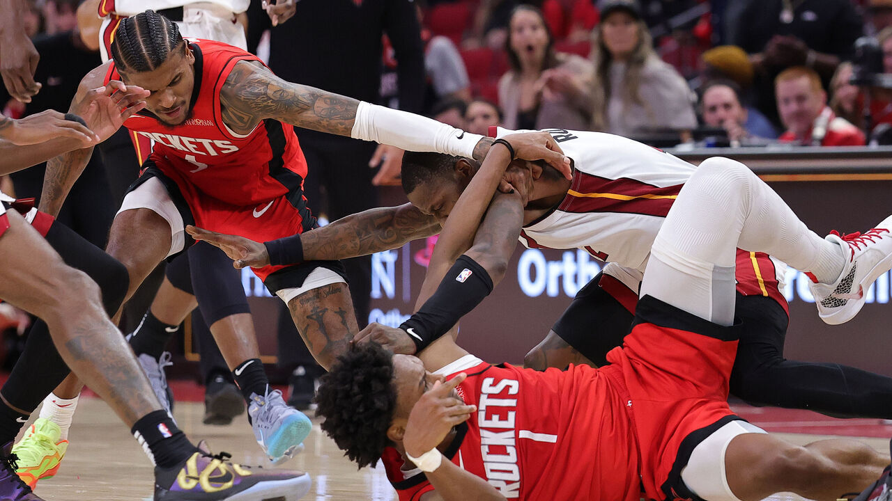 HOUSTON, TEXAS - DECEMBER 29: Jalen Green #4 and Amen Thompson #1 of the Houston Rockets fight with Terry Rozier #2 of the Miami Heat during the second half at Toyota Center on December 29, 2024 in Houston, Texas.