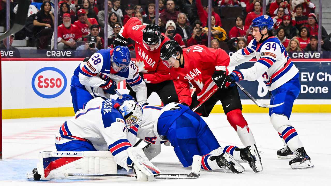 OTTAWA, CANADA - DECEMBER 31: Goaltender Trey Augustine #1 and teammate Zeev Buium #28 of Team USA defend the puck against Carson Rehkopf #16 and Bradly Nadeau #10 of Team Canada in the second period of the Group A match during the 2025 IIHF World Junior Championship at Canadian Tire Centre on December 31, 2024 in Ottawa, Ontario, Canada.