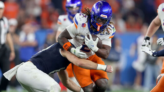 GLENDALE, AZ - DECEMBER 31: Boise State Broncos running back Ashton Jeanty (2) gets stopped by Penn State Nittany Lions linebacker Dominic DeLuca (0) for a short gain during the CFP Quarterfinal Vrbo Fiesta Bowl featuring the Penn State Nittany Lions vs. the Boise State Broncos on December 31, 2024 at State Farm Stadium in Glendale, Arizona.