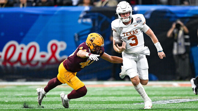 ATLANTA, GA JANUARY 01: Quarterback Quinn Ewers #3 of the Texas Longhorns runs past Linebacker Keyshaun Elliott #44 of the Arizona State Sun Devils during the Texas Longhorns versus Arizona State Sun Devils College Football Playoff Quarterfinal at the Chick-fil-A Peach Bowl on January 1, 2025, at Mercedes-Benz Stadium in Atlanta, GA.