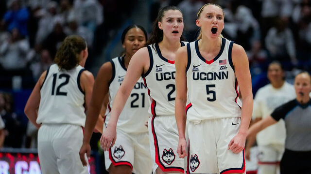 HARTFORD, CONNECTICUT - DECEMBER 21: Sarah Strong #21, Morgan Cheli #23 and Paige Bueckers #5 of the Connecticut Huskies react during the second half of an NCAA women's basketball game against the USC Trojans at the XL Center on December 21, 2024 in Hartford, Connecticut.