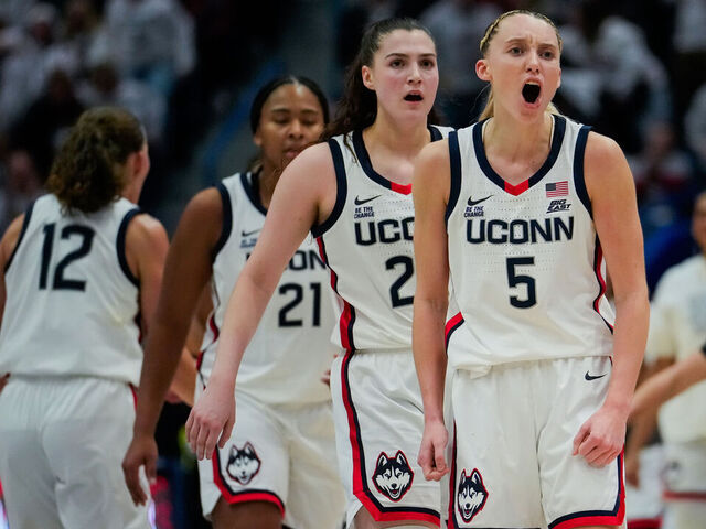 HARTFORD, CONNECTICUT - DECEMBER 21: Sarah Strong #21, Morgan Cheli #23 and Paige Bueckers #5 of the Connecticut Huskies react during the second half of an NCAA women's basketball game against the USC Trojans at the XL Center on December 21, 2024 in Hartford, Connecticut.