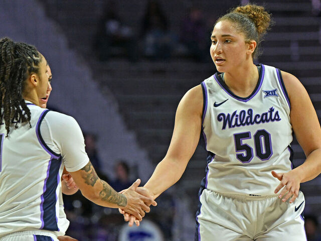 MANHATTAN, KS - DECEMBER 18: Ayoka Lee #50 of the Kansas State Wildcats gets a hand from teammate Zyanna Walker #1 after a play in the first half against the New Mexico State Aggies at Bramlage Coliseum on December 18, 2024 in Manhattan, Kansas.