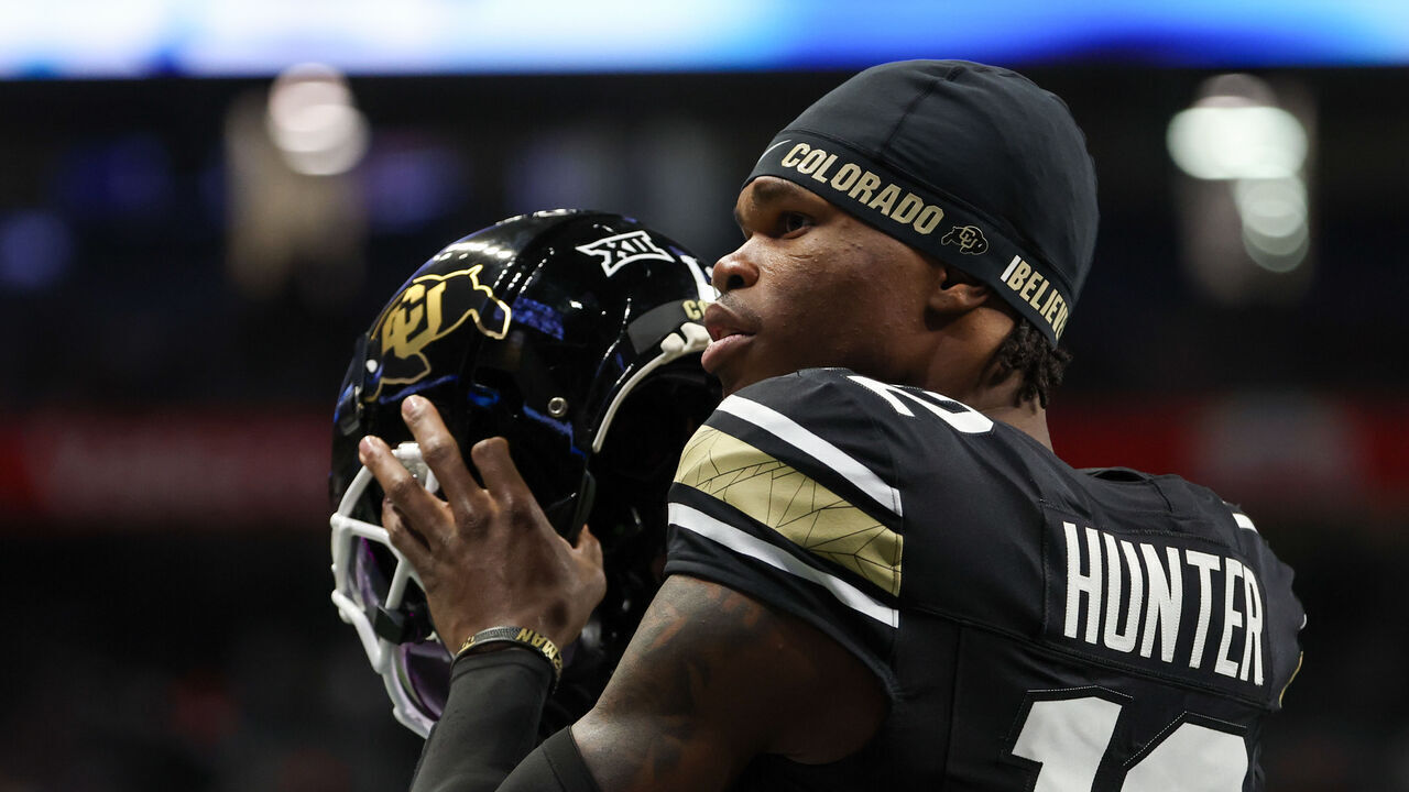 SAN ANTONIO, TX - DECEMBER 28: Colorado Buffaloes wide receiver Travis Hunter (12) readies to put his helmet on before the football game between BYU Cougars and Colorado Buffalos on December 28, 2024, at the Alamodome in San Antonio, Texas.