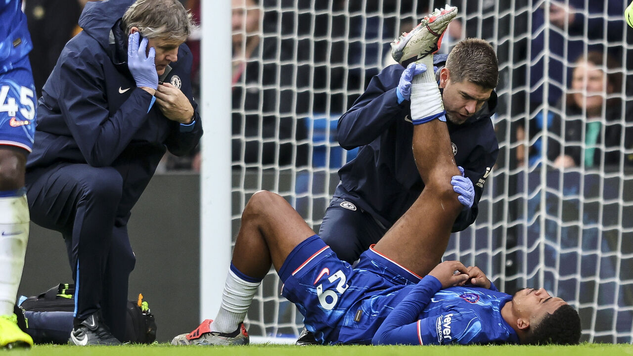 LONDON, ENGLAND - DECEMBER 01: Wesley Fofana of Chelsea goes down injured and is treated during the Premier League match between Chelsea FC and Aston Villa FC at Stamford Bridge on December 01, 2024 in London, England.